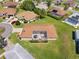 Aerial view showcasing a well-maintained backyard with screened lanai and lush green lawn in a residential setting at 17645 Se 117Th Cir, Summerfield, FL 34491