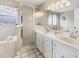 Bathroom features a large soaking tub, glass door shower, and double sink vanity at 17645 Se 117Th Cir, Summerfield, FL 34491