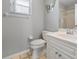 Clean bathroom showcasing a tiled shower, toilet, sink and vanity at 17645 Se 117Th Cir, Summerfield, FL 34491