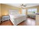 Bright bedroom boasts stylish furnishings, hardwood floors, and an abundance of natural light at 17645 Se 117Th Cir, Summerfield, FL 34491
