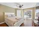 Warm and inviting bedroom with a ceiling fan, wood floors and sliding glass door at 17645 Se 117Th Cir, Summerfield, FL 34491