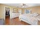 The main bedroom features wood floors, access to the patio, ensuite bath and walk in closet at 17645 Se 117Th Cir, Summerfield, FL 34491