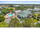 Aerial view of a community center with pool, tennis courts and well-manicured landscaping at 17645 Se 117Th Cir, Summerfield, FL 34491