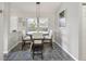 Cozy dining room featuring tiled flooring and a charming chandelier above the table at 17645 Se 117Th Cir, Summerfield, FL 34491