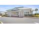 Exterior view of the community fitness center featuring a clean design with ample parking and lush landscaping at 17645 Se 117Th Cir, Summerfield, FL 34491