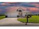 Charming one-story home with a well-maintained lawn, two-car garage, and beautiful evening sky at 17645 Se 117Th Cir, Summerfield, FL 34491