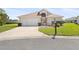 Charming one-story home with a well-maintained lawn, two-car garage, and beautifully manicured shrubs at 17645 Se 117Th Cir, Summerfield, FL 34491