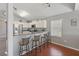 Modern kitchen featuring stainless steel appliances, white cabinets, granite countertops, and a breakfast bar at 17645 Se 117Th Cir, Summerfield, FL 34491
