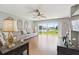Spacious living room boasting a sliding glass door with a view to the backyard at 17645 Se 117Th Cir, Summerfield, FL 34491