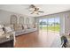 Bright living room featuring a comfortable sofa and a large window for natural light at 17645 Se 117Th Cir, Summerfield, FL 34491