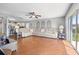 Open-concept living room flowing into the kitchen and a large sofa for relaxing and entertaining at 17645 Se 117Th Cir, Summerfield, FL 34491