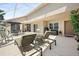 Spacious patio furnished with lounge chairs, dining set, and a covered seating area at 17645 Se 117Th Cir, Summerfield, FL 34491