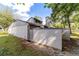 The home has an enclosed backyard with a white fence, mature trees and landscaping at 2042 Se 37Th Court Circle Cir, Ocala, FL 34471