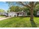 Well-maintained home with an attached garage, mature trees, and a lush green lawn at 2042 Se 37Th Court Circle Cir, Ocala, FL 34471