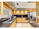Well-lit kitchen with wooden cabinets, granite countertops, and stainless steel appliances at 2042 Se 37Th Court Circle Cir, Ocala, FL 34471
