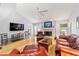 Spacious living room boasts a vaulted ceiling, fireplace, and wood flooring at 2042 Se 37Th Court Circle Cir, Ocala, FL 34471