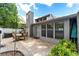 Private outdoor patio featuring table and chairs, enclosed by a privacy wall and landscaped with greenery, creating an inviting retreat at 2042 Se 37Th Court Circle Cir, Ocala, FL 34471