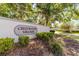Entrance sign for Crestwood Village with lush landscaping in front of the sign at 2042 Se 37Th Court Circle Cir, Ocala, FL 34471