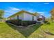 Home exterior with a screened-in lanai, green lawn, and lush landscaping at 2358 Nw 59Th Ter, Ocala, FL 34482