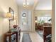 Inviting foyer with tiled floor, decorative lighting, and a view of the living room and front door at 2358 Nw 59Th Ter, Ocala, FL 34482
