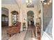 Inviting foyer with tiled floor, decorative lighting, and a view of the dining room and display cabinet at 2358 Nw 59Th Ter, Ocala, FL 34482
