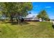 Charming single-story home featuring a well-manicured lawn, mature tree, and a two-car garage with light colored driveway at 2358 Nw 59Th Ter, Ocala, FL 34482