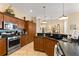 A modern kitchen is equipped with stainless steel appliances, granite countertops, and ample cabinet space for storage at 2358 Nw 59Th Ter, Ocala, FL 34482