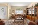 Inviting living room featuring a large window, a comfortable sofa, and a classic-style display cabinet with decorations at 2358 Nw 59Th Ter, Ocala, FL 34482