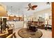 Open-concept living room with a ceiling fan, comfortable seating, and seamless flow to the kitchen and dining areas at 2358 Nw 59Th Ter, Ocala, FL 34482