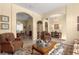Inviting living room showcasing comfortable seating, elegant décor, and seamless transition to the dining area at 2358 Nw 59Th Ter, Ocala, FL 34482