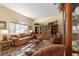 Cozy living room with a large window, a comfortable sofa, and a classic-style display cabinet with decorations at 2358 Nw 59Th Ter, Ocala, FL 34482