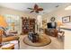 Comfortable living room with stylish furnishings, a ceiling fan, and ample natural light from the windows at 2358 Nw 59Th Ter, Ocala, FL 34482