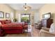 The bedroom features a ceiling fan, patio access, and comfortable seating for a serene and private atmosphere at 2358 Nw 59Th Ter, Ocala, FL 34482