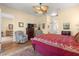 A spacious main bedroom boasts comfortable seating, a ceiling fan, and an ensuite bathroom for ultimate relaxation at 2358 Nw 59Th Ter, Ocala, FL 34482