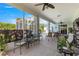 Inviting screened-in patio with comfortable seating and tranquil views of the lush backyard and pool at 2358 Nw 59Th Ter, Ocala, FL 34482
