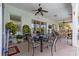 Spacious covered patio with multiple seating areas and ceiling fans, perfect for outdoor entertaining at 2358 Nw 59Th Ter, Ocala, FL 34482