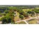 Expansive aerial view of a property bordered in red, showcasing the landscape and outlining its perimeter at 2720 Se 145Th St, Summerfield, FL 34491