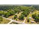 Gorgeous aerial view of land with mature trees, a storage building, and a home, offering privacy and space at 2720 Se 145Th St, Summerfield, FL 34491