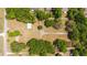 Overhead shot reveals a large property with outbuilding and multiple driveways amid mature trees and green space at 2720 Se 145Th St, Summerfield, FL 34491