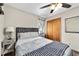 Bedroom featuring a patterned headboard, ceiling fan, and hardwood floors at 2720 Se 145Th St, Summerfield, FL 34491