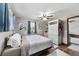 Comfortable bedroom showcasing a ceiling fan, closet, and windows for natural light at 2720 Se 145Th St, Summerfield, FL 34491