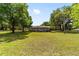 Charming single-story home nestled in a spacious, tree-filled yard with a traditional white picket fence at 2720 Se 145Th St, Summerfield, FL 34491