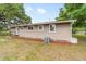 Cozy house exterior showcasing mature trees, well-kept landscaping, and a peaceful backyard at 2720 Se 145Th St, Summerfield, FL 34491