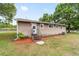 Quaint house exterior featuring a well-maintained yard, mature trees, and a peaceful setting at 2720 Se 145Th St, Summerfield, FL 34491