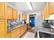 Bright kitchen featuring wood cabinets, stainless steel appliances, and modern sink at 2720 Se 145Th St, Summerfield, FL 34491