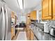 Open kitchen with stainless steel appliances leading to a dining area at 2720 Se 145Th St, Summerfield, FL 34491