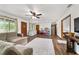 Cozy living room with wood floors, a sectional sofa, and abundant natural light from the windows at 2720 Se 145Th St, Summerfield, FL 34491