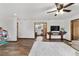 Open living room featuring wood floors, white walls, and access to dining room, creating a seamless flow at 2720 Se 145Th St, Summerfield, FL 34491