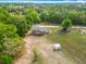 Aerial view of home showcasing expansive lot, outbuildings and surrounding mature trees at 2800 Sw 141St Ct, Ocala, FL 34481