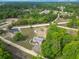 An aerial view showcases the home and surrounding wooded areas under a blue sky at 2800 Sw 141St Ct, Ocala, FL 34481